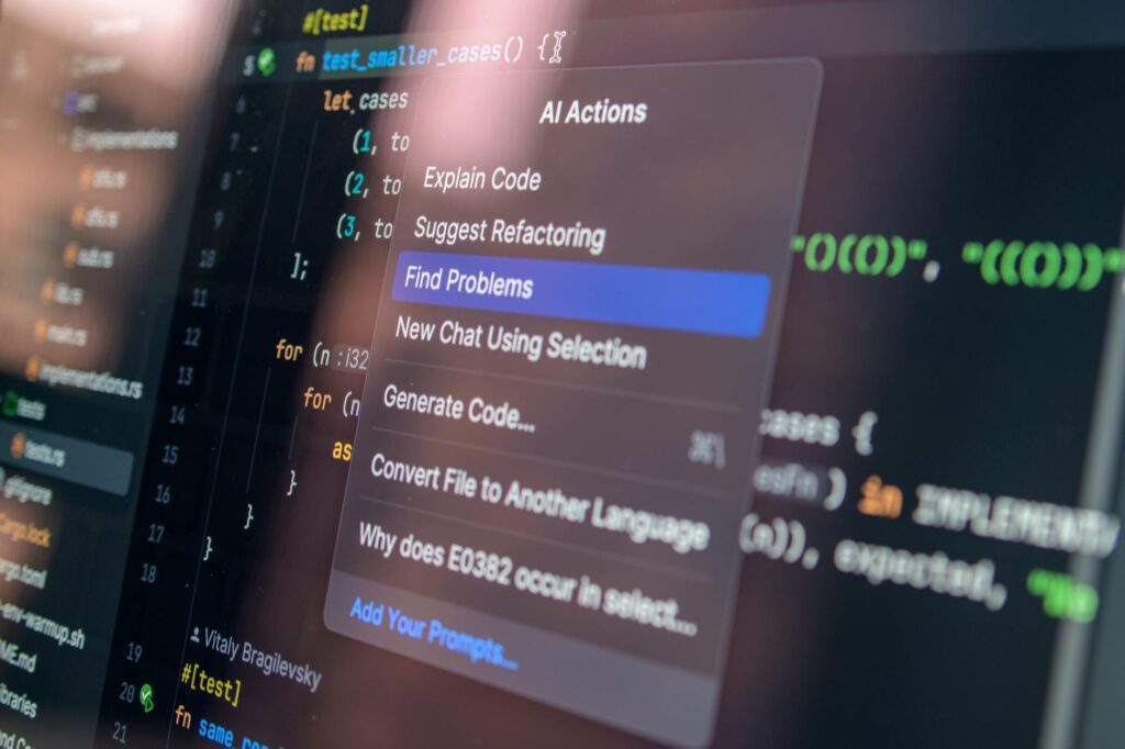 Close-up of AI-assisted coding with menu options for debugging and problem-solving. (Photo by Daniil Komov on Pexels)