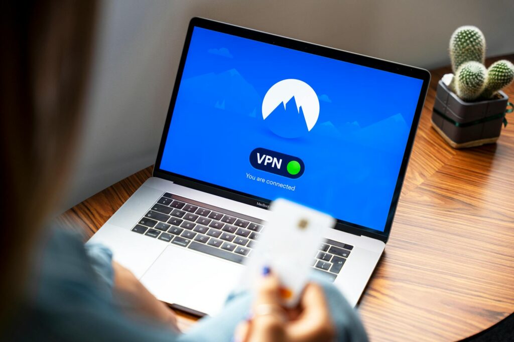 A person using a VPN on a laptop, symbolizing secure internet browsing in a modern indoor setting. (Photo by Stefan Coders on Pexels)