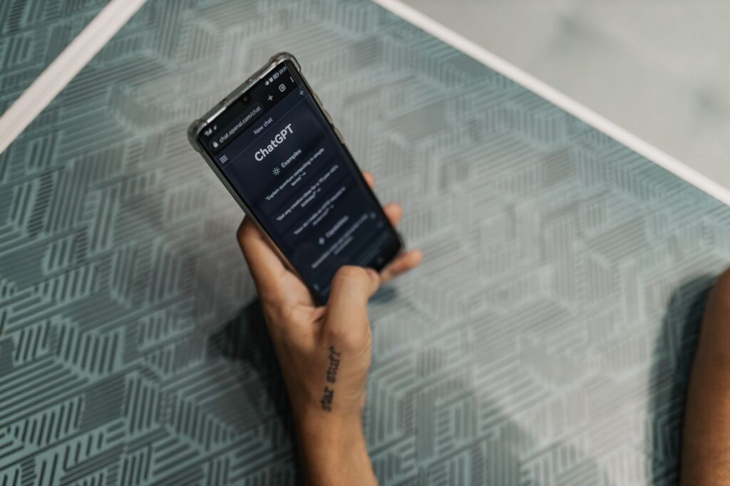 Close-up of a person holding a smartphone displaying the ChatGPT application interface on a patte... (Photo by Matheus Bertelli on Pexels)